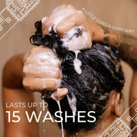 Hands lathering shampoo into dark curly hair; lasts up to 15 washes