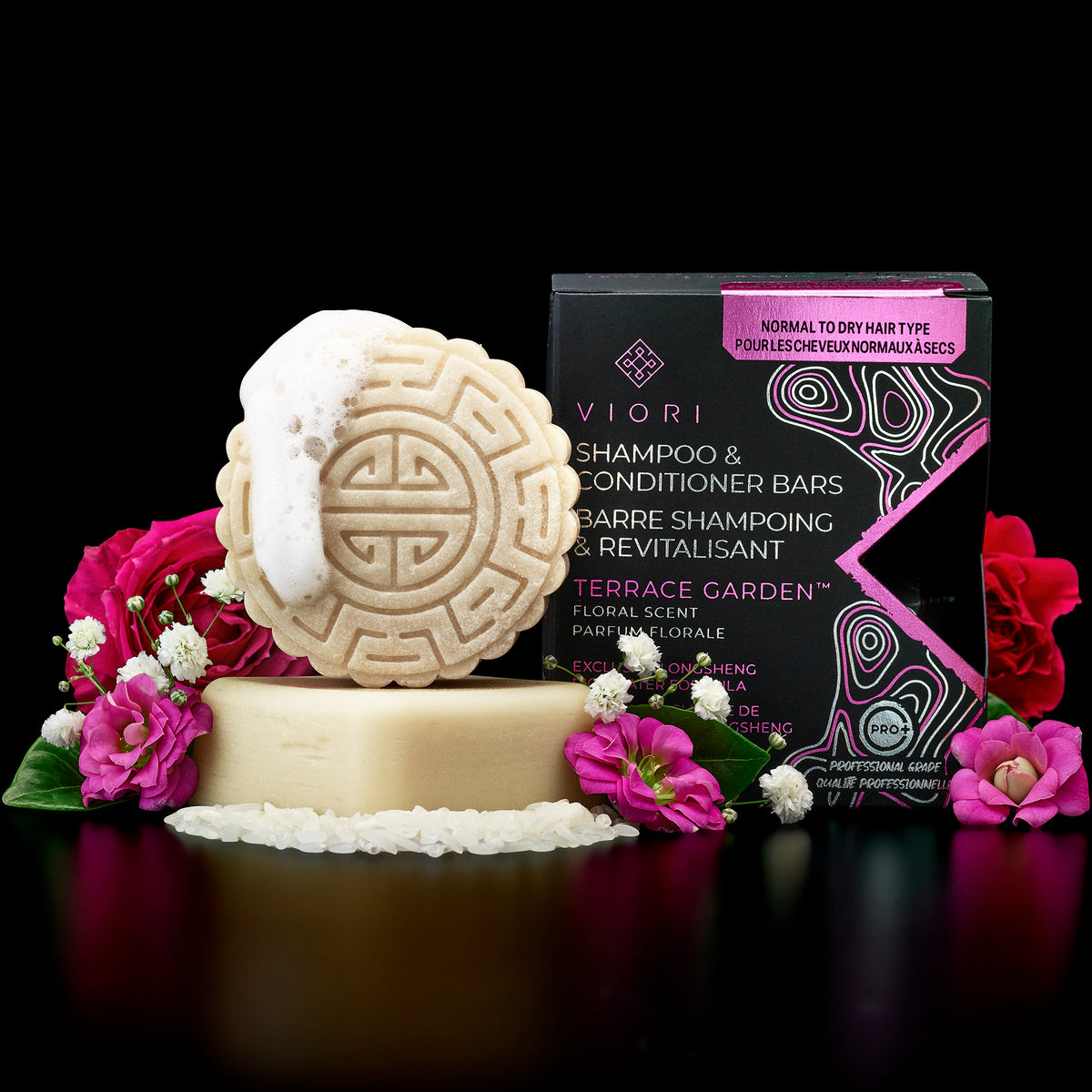 Terrace Garden shampoo and conditioner bars with their box and pink flowers