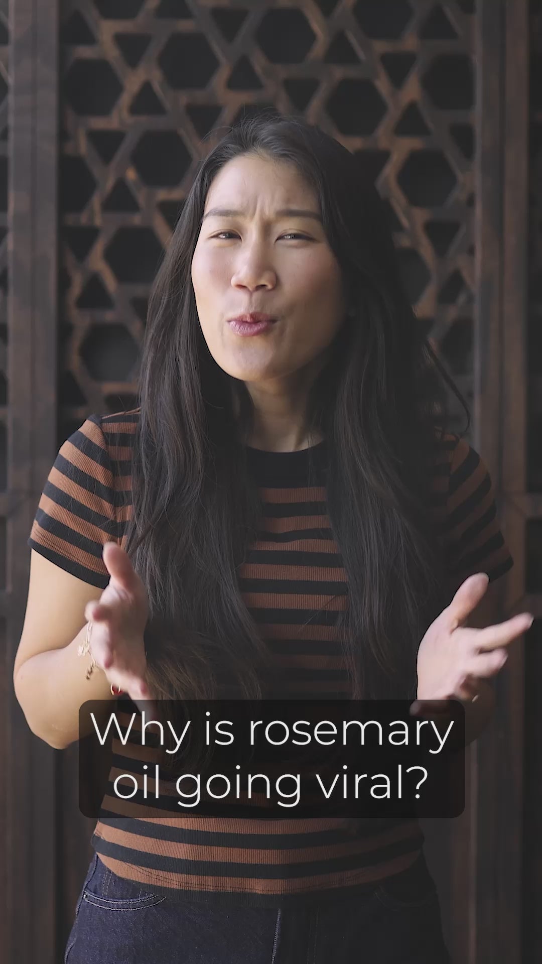 Video: woman with long dark hair talking to the camera, captioned "Why is rosemary oil going viral?"